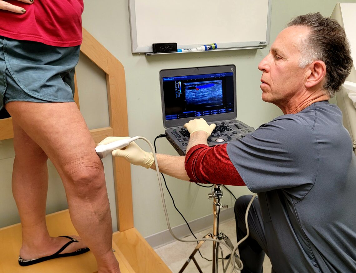 Dr. Schmetterer reviewing follow up ultrasound results with a patient experiencing leg swelling after vein treatment in Youngstown